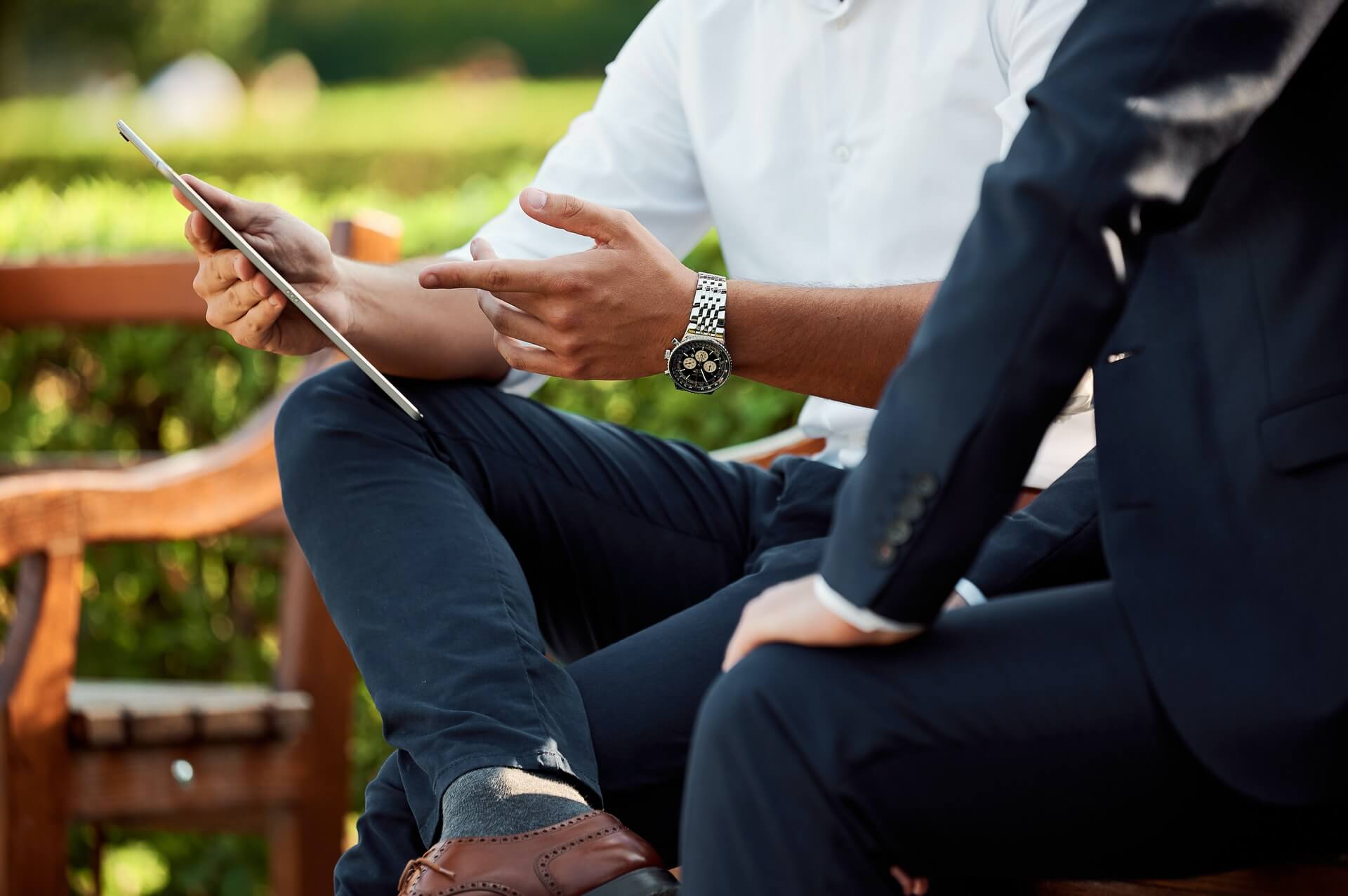 Two business men having a meeting in the park